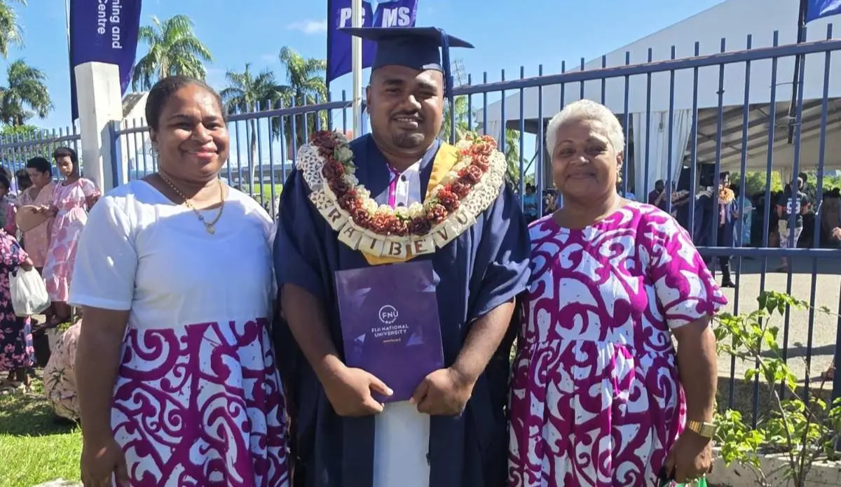 From left: Nanise Sivo Koroirua (elder sister), Kitione Raibevu (graduate), and Anaseini Balenasiga Saukuru (mother) during the Fiji National University graduation ceremony at the FMF Gymnasium in Suva on May 11, 2026. Photo: Zaheen Bi