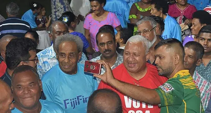 FijiFirst leader, Voreqe Bainimarama takes a selfie with a supporter during the party rally at Nawaka District School grounds in Nadi on November 19, 2022. Photo: Salote Qalubau