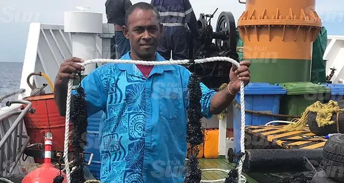 Ministry of Fisheries staff, Charlie Doughty, holding up a Fisheries Aggregate Device [FAD] which is being distributed in Yasawa onboard the Bai Ni Takali on June 17, 2020. Photo: Kelera Sovasiga