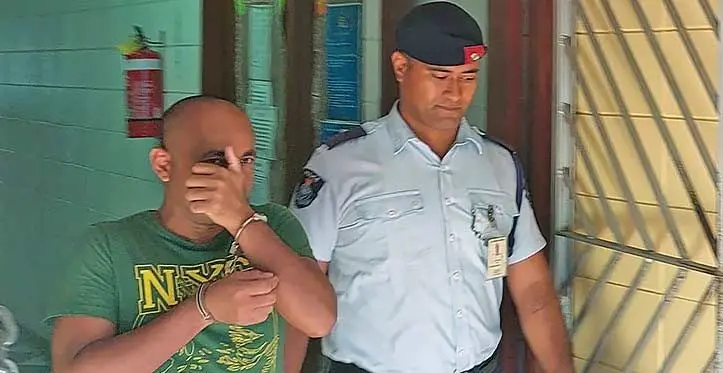 Mohammed Masum escorted by a Policeman at the High Court in Lautoka. Photo: Salote Qalubau