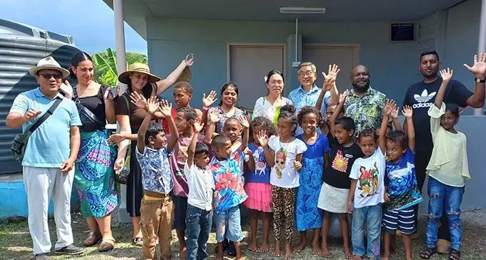 Labsa Market. From left, Paul Kim , Pastor Chang-Ho-Lee and his wife Yong-Mi-Lee (3rd and 4th from right, back row) and HART Deputy CEO Lorima Rokosawa (2nd from right) with volunteer teachers and some kindergarten children after the opening of the kindergarten’s new abolition block on December 8, 2022. Photo: Nicolette Chambers.