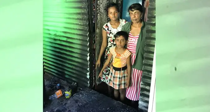 Dhan Raji with her granddaughters Swastika Reddy, 16 and Jesleen Prasad, 7, pointing at the door corner where the fire was said to have started, at their home at Benau in Labasa on April 23, 2020. Photo: Shratika Naidu