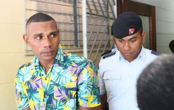 Ilaisa Tanoa Degei escorted by a police officer to the Lautoka High Court.