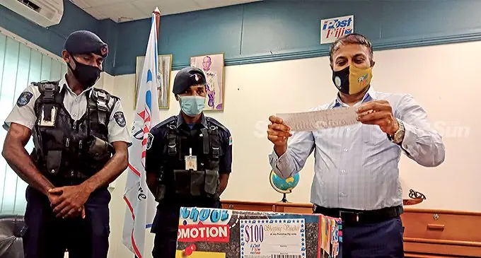 Post Fiji chief executive officer Anirudha Bansod carrying out the draw for the  back to school  promotion in the presence of Police constables Petero Tuisiga and Beniyamino Kameli where 25 winners were announced on March 17 2022. Picture Laiseana Nasiga.