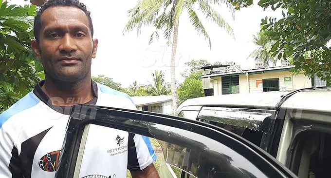Adriu Naisiroki shows the partially broken drivers window of his taxi. Photo: Salote Qalubau