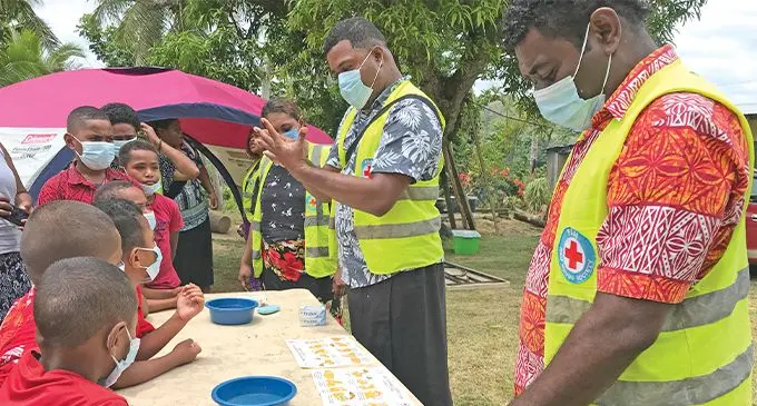 Red Cross Volunteer Pita Saladoka demonstrates hand washing practises during the Disaster awareness programme at Lovelove Village. Photo: Laisa Lu  