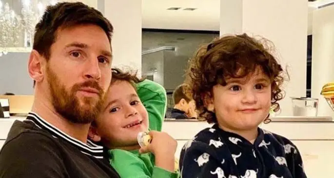 Photo from FC Barcelona's Lionel Messi's Instagram account shows Messi posing with two of his children at home during lockdown in Spain on March 14, 2020.