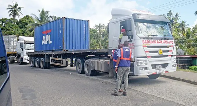 Land Transport Authority enforcement officers check on trucks at a checkpoint in Nabua on June 12, 2019. Photo: Ronald Kumar