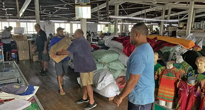 Members of the Rotary Club of Lautoka packaging the items to be sent to Vanua Levu. 