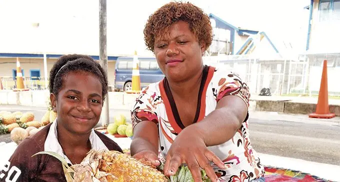 Milika Tinanisautu (left) with her aunty Milika Tinanisautu (snr)of Nadrano Village, Tailevu, selling their produce at the Suva Market on January 1,2020. Photo: Ronald Kumar.