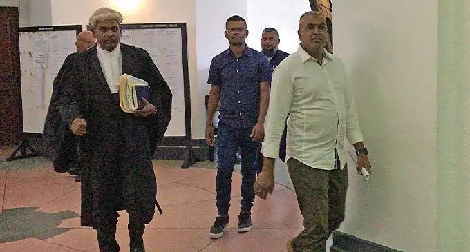 From left: Lawyer Jitend Reddy with his clients Roneel Ravinesh Chand and Karim Begg outside the High Court in Suva. Photo: Ashna Kumar