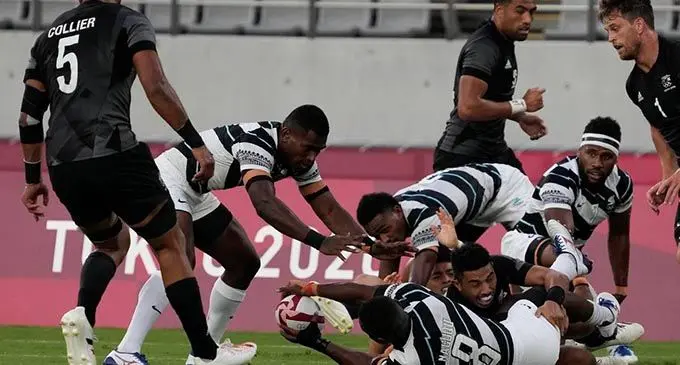 Team Fiji men’s rugby sevens winger Aminiasi Tuimaba goes to the breakdown to assist Waisea Nacuqu (on the ground) against New Zealand in the gold final of the Tokyo 2020 Olympic Games at the Tokyo Stadium, Japan, on July 28, 2021. Fiji won 27-12 to retain the Olympic Games gold medal. Photo: World Rugby