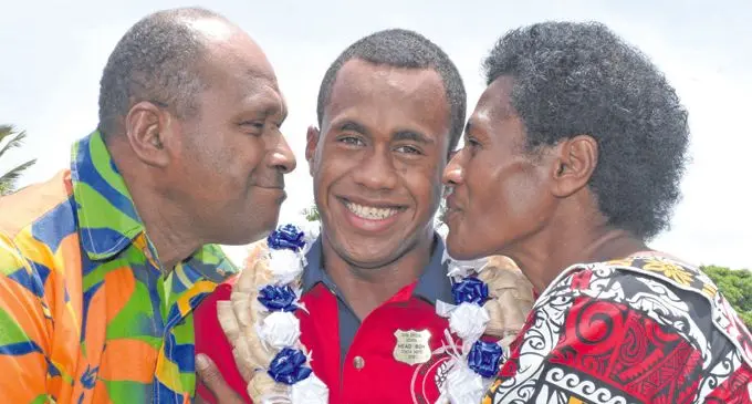 Suva Special School Head Boy Tevita Kete with Parents Jope and Katalaini Kete following his prefect induction on February 9, 2018. Photo: Ronald Kumar.