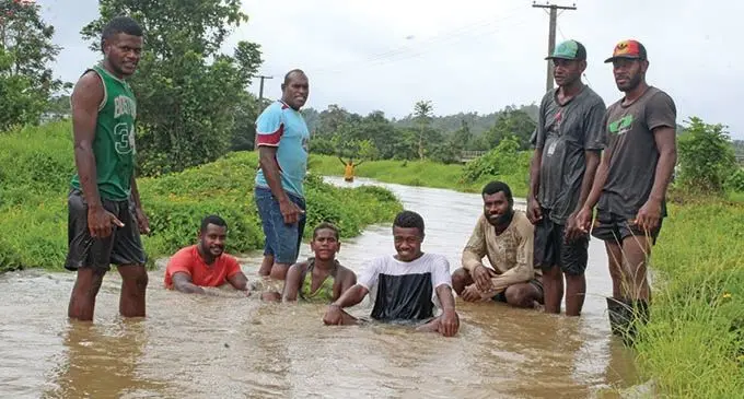 Youths from Naqali Village in Naitasiri at a flooded road on  December 29, 2018. Photo: Simione Haravanua