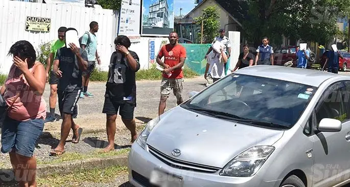 People accused of breaking the national curfew and social gathering restrictions are escorted by Police officers to the Nadi Magistrates Court. Photo: Mereleki Nai