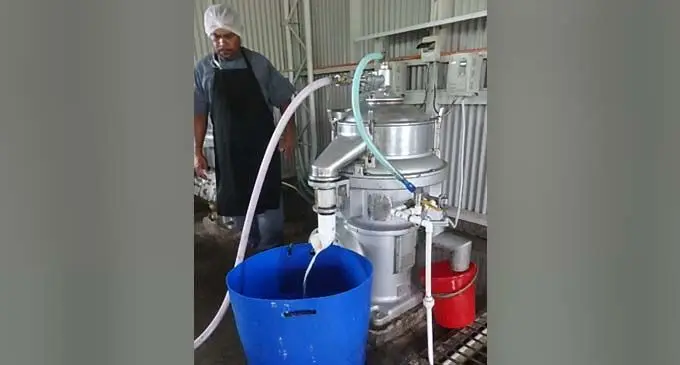 Ilisoni Sirilo with the centrifuge at Pacific Produce in Taveuni.