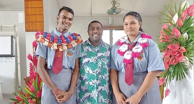 From left: Head boy Divnesh Chandra, Student Council Coordinator and Nabua Secondary School teacher Rajnesh Lingam with head girl Susan Malaefono after the prefects induction ceremony on April 29, 2022.