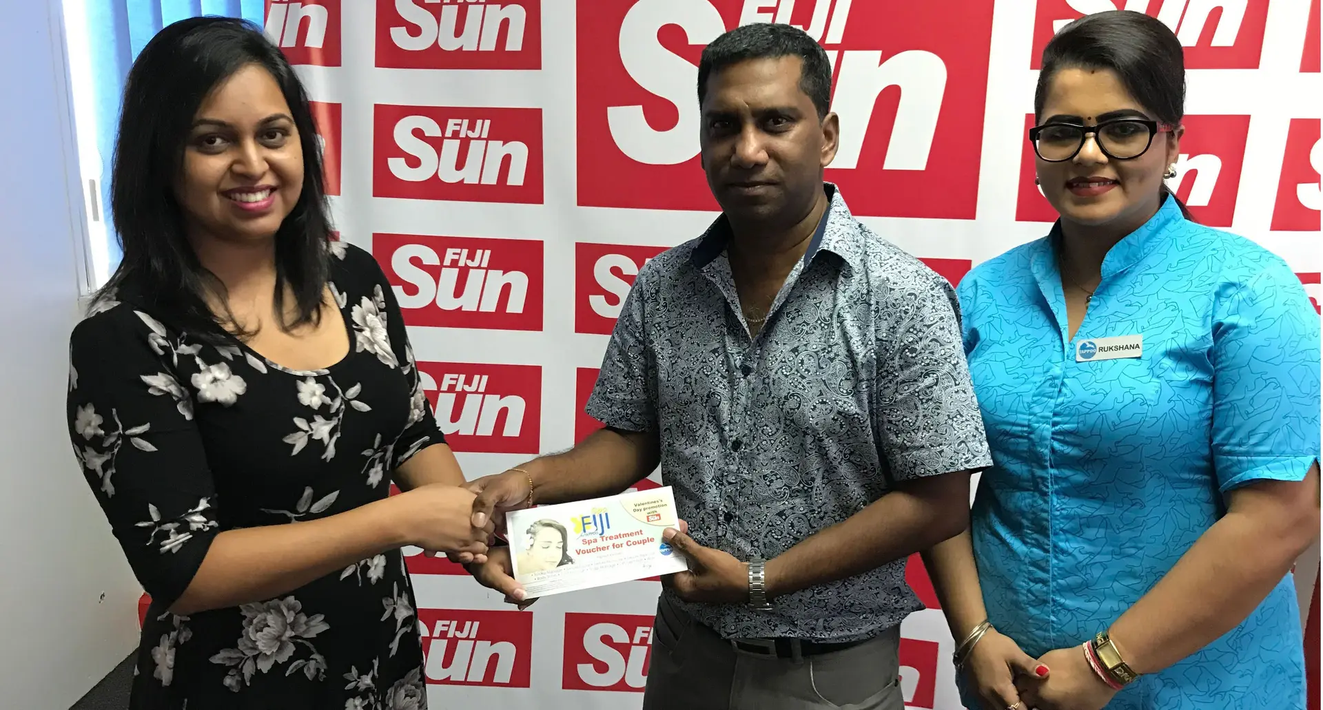 Valentines Promo winner Rajnesh Ravindra (centre)  at the Fiji Sun head office during the handover of the voucher on March 1st 2018. Photo: Roneel Karthik