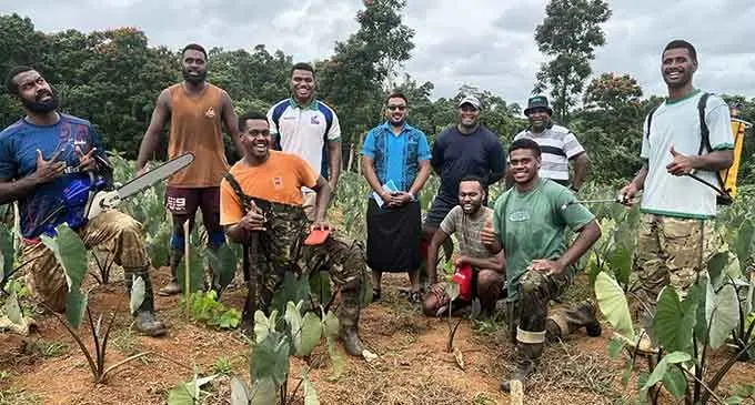 Seremaia Bai (sixth from left) with one of his AgriRugby farming team in taro field on July 11, 2022. Photo: NZ Rugby World