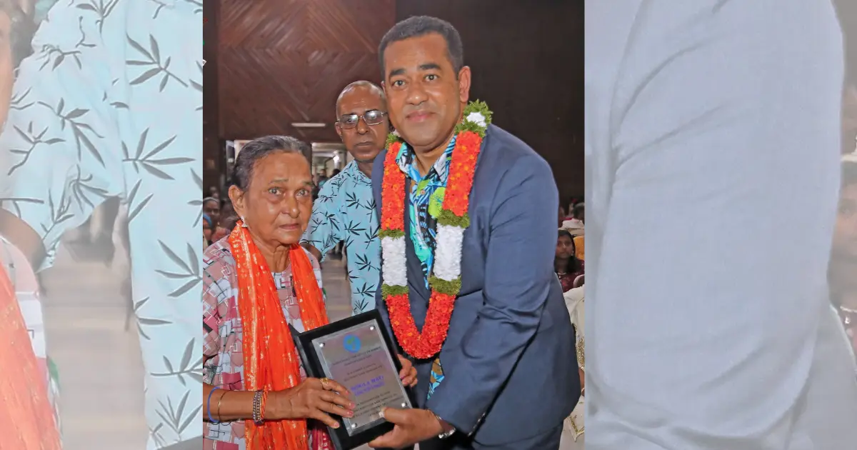 Kokila Wati, 84, receives her plaque from Minister for Lands Filimoni Vosarogo as his son Rajeshwar Prasad looks on. Photo: Fiji Government