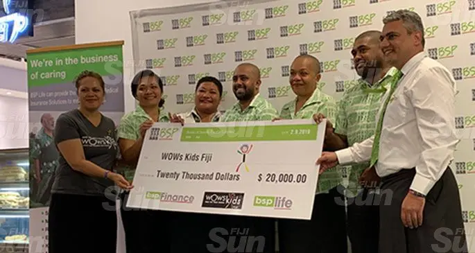 WOWS Kids Fiji co-founder Sina Kami (left) and BSP Life managing director Michael Nacola (right) with staff of BSP Group during the cheque handover on September 2, 2019. Photo: Krishan Raj