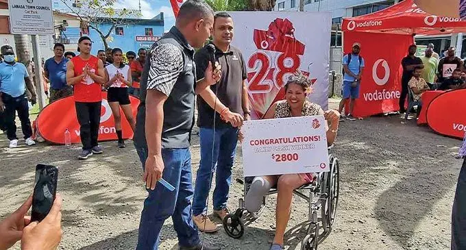 Kitty Saukilagi with her cash prize in Labasa on July 21, 2022. Photo: Vodafone Fiji