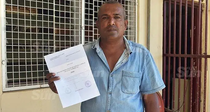 Mahend Prasad showing his judgement sheet after being acquitted by the Magistrates Court in Labasa.