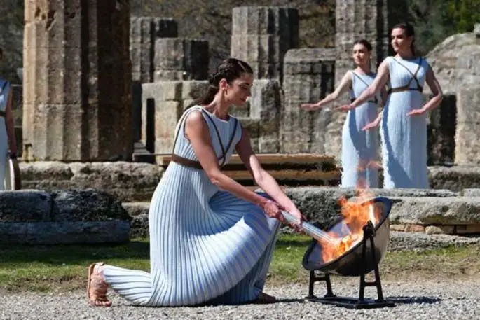 Greek actress Xanthi Georgiou, playing the role of an ancient Greek High Priestess, lighting the torch of the Olympic Flame during the flame lighting ceremony for Tokyo 2020 Olympic Games in Olympia, Greece on March 12, 2020. (Photo by Antonis Nikolopoulos/Xinhua)