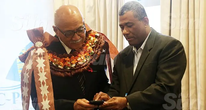 From left: President Jioji Konrote, College of Medicine, Nursing and Health Science Dean Dr William May tests the FoodSwitch Fiji App after its official launch at the Tanoa Hotel in Suva. Photo: Kelera Sovasiga