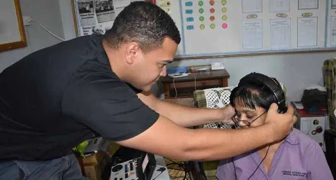 Frank Hilton audiology team volunteer Madison Linares examining Chandra Wati at the Labasa Special School February 19, 2018. Photo: Wati Talebula
