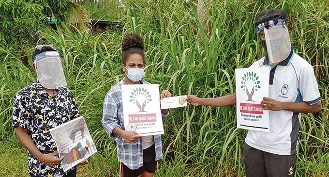  One nation our people youth foundation President Abdul Zorhab (right) and members Loata Uluinaceva and Elvish Naicker with the food vouchers. 