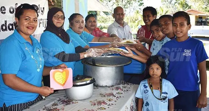 Austin Matarugu (left) with Voice of the Needy Foundation members and students of Sabeto District School in Nadi. Photo: Waisea Nasokia