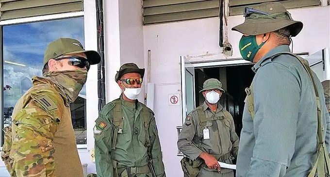 Lieutenant Jerome Taoi receives briefing from an Australian Defence Force soldier at the Honiara International Airport. Photo: Staff Sergeant Peni Waqaimoala