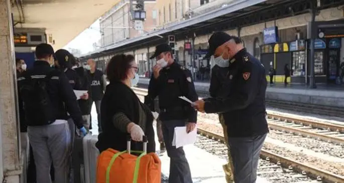 Police officers check on passengers at Bologna Central Station in Bologna, Italy, May 4, 2020. (Photo by Gianni Schicchi/Xinhua)