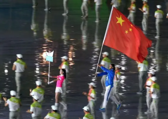 Athlete flagbearer (R) from China enters the stadium during the Athletes Parade at the opening ceremony for Nanjing 2014 Summer Youth Olympic Games in Nanjing, capital of east China's Jiangsu Province, Aug. 16, 2014. (Xinhua/Yan Yan)
