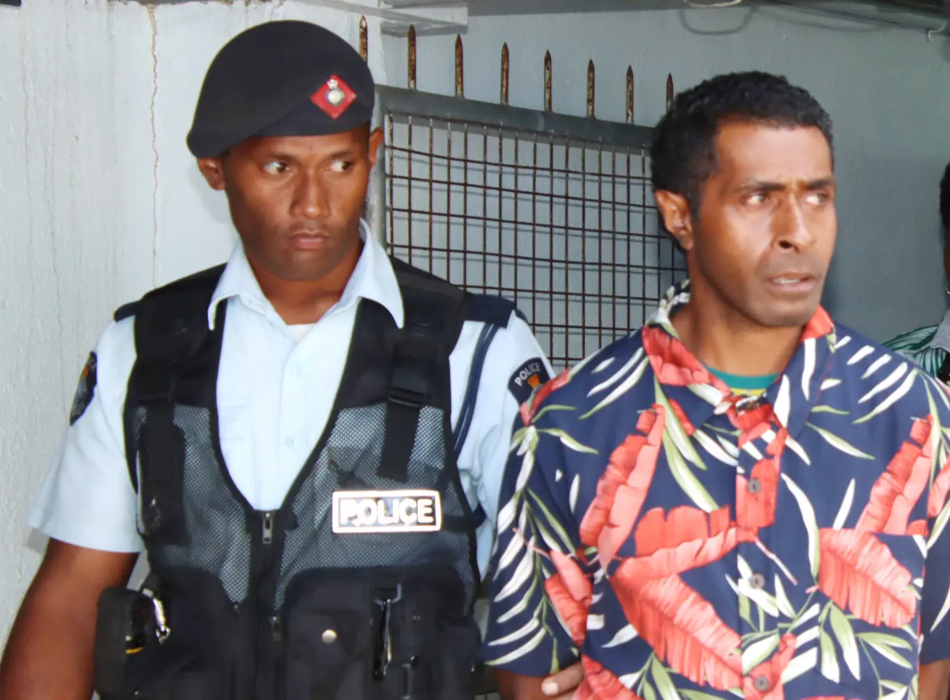 Savenaca Damuni following (right) escorted by a police officer after his sentencing at the High Court in Suva.