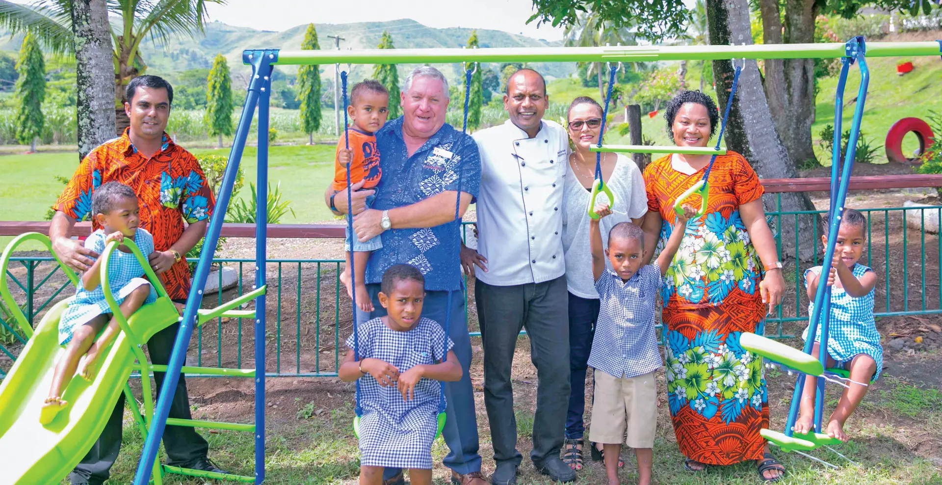 Outrigger Fiji General Manager, Peter Hopgood (holding child), Executive Chef, Shailesh Naidu with partner, Rita handing over the playground to the management and children at the Nadrala Sangam School. Photo: OUTRIGGER FIJI BEACH RESORT