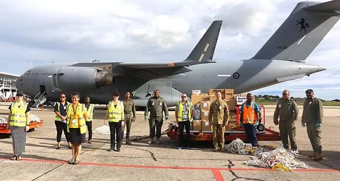 Royal Australian Air Force C-17 aircraft crew with Nadi International Airport staff members and Republic of Fiji Military Forces personnel as they offload the COVID-19 test kits and TC Harold relief items on April 30, 2020. Photo: Australian High Commission