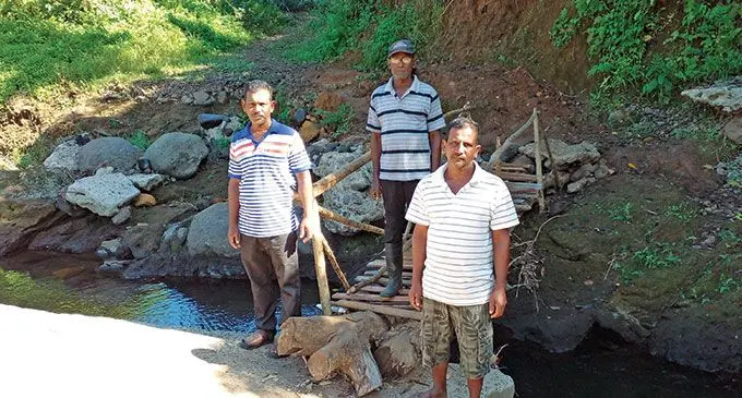 Members of Deo Karan Road committee at the damaged crossing