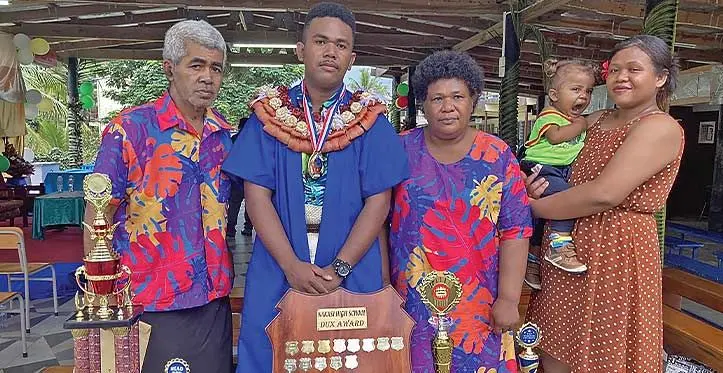 Nafitalai Qareiwasa is flanked by family at the Nakasi High School prizegiving ceremony.