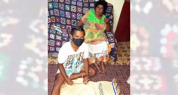 Mosese Nasoso Waletu (on the floor) with his grandmother, Laisani Cagidamata, at Sikituru Village in Nadi.