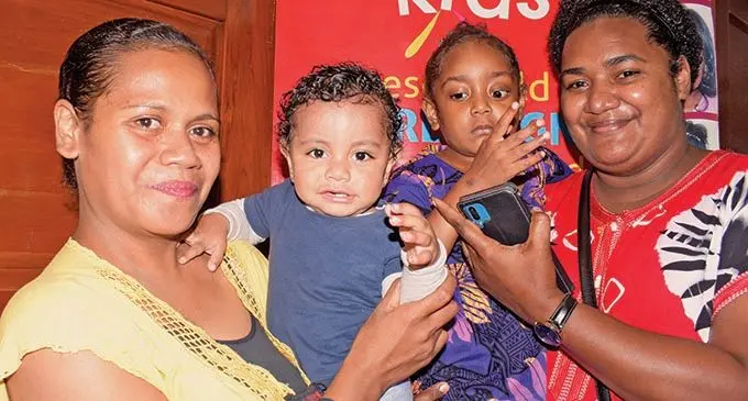 Safe in their mother's arms cancer survivers Elijah Moriah 1 and Eceli Hadassah 5 with their mum, Vakaloloma Sugu and Peau Susu during International Childhood cancer day on February 15, 2022. Photo: Ronald Kumar.