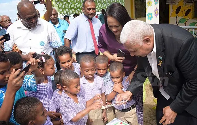 Minister for Health Dr. Iferemi Waqainabete, Minister for Education Rosy Akbar and Prime Minister Voreqe Bainimarama  shares cake with Suvavou Kindergarten students after the opening on August 12, 2020. Photo: Ronald Kumar.