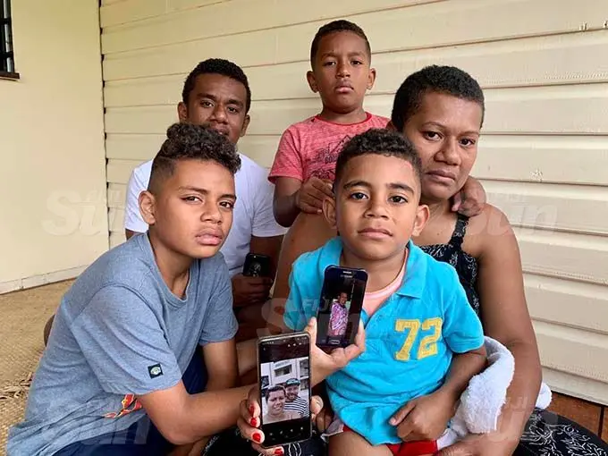 Wife of accident victim Olivia Bulutani with her sons holding the picture of their late father and grandmother. (back from left) Asaeli Bulutani, 17, Ledua Bulutani Junior, 8, (front from left) Robert Bulutani, 12, and Jone Bulutani, 5, at their home in Namadi, Suva on September 21, 2020. Photo: Inoke Rabonu