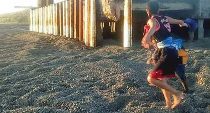 Children play on pumice at the Tubou Jetty, Lakeba.