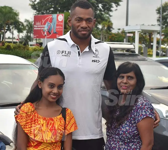 Fiji Airways 7s rep Sevuloni Mocenacagi is flanked by fans Pooja Chand (left) and Kamrul Nisha (right) at the Nadi International Airport on March 11, 2020.  Photo: Waisea Nasokia