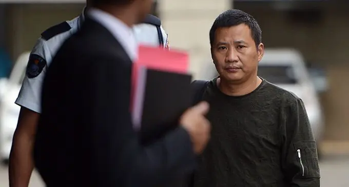 Wang Qi Young 43 escorted to Court in Suva on May 21, 2019. Photo: Ronald Kumar
