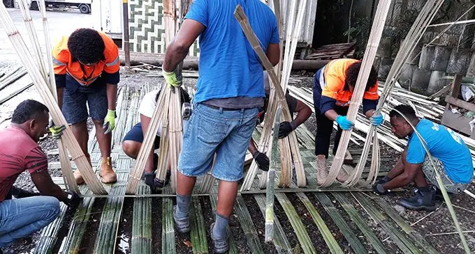 Habitat for Humanity Fiji, Shelter programme PFID carpenters weaving bamboo for the wall cladding.  Photo: Habitat for Humanity Fiji