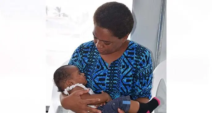 Minister for Women, Children and Poverty Mereseini Vuniwaqa carrying six month old Litia Grace at Seaqaqa on January 22, 2021.