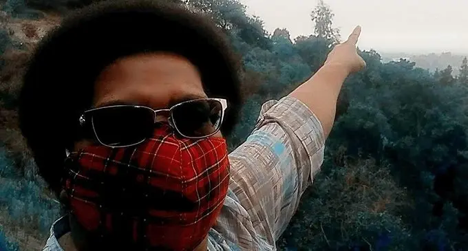 Vasiti Ritova pointing at a site of the wild fires in  Santa Cruz County